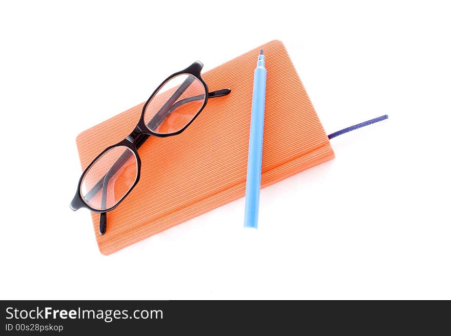 Red calendar and black glasses isolated on a white background