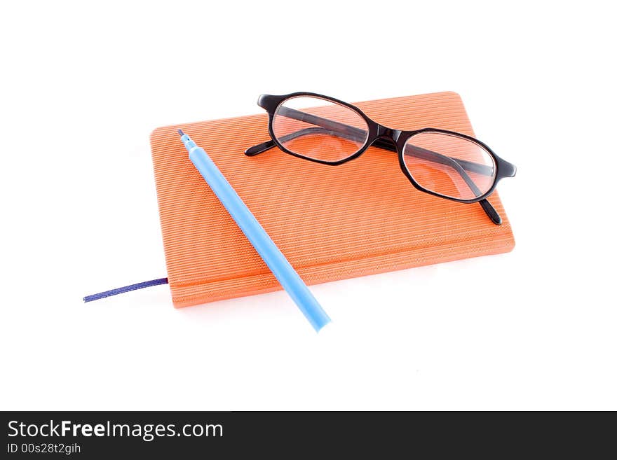 Red calendar and black glasses isolated on a white background