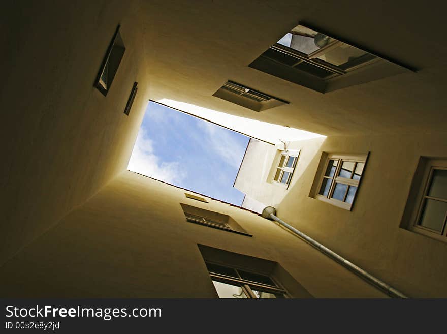 Blue sky, view from below. Courtyard in old town (Riga, Latvia)