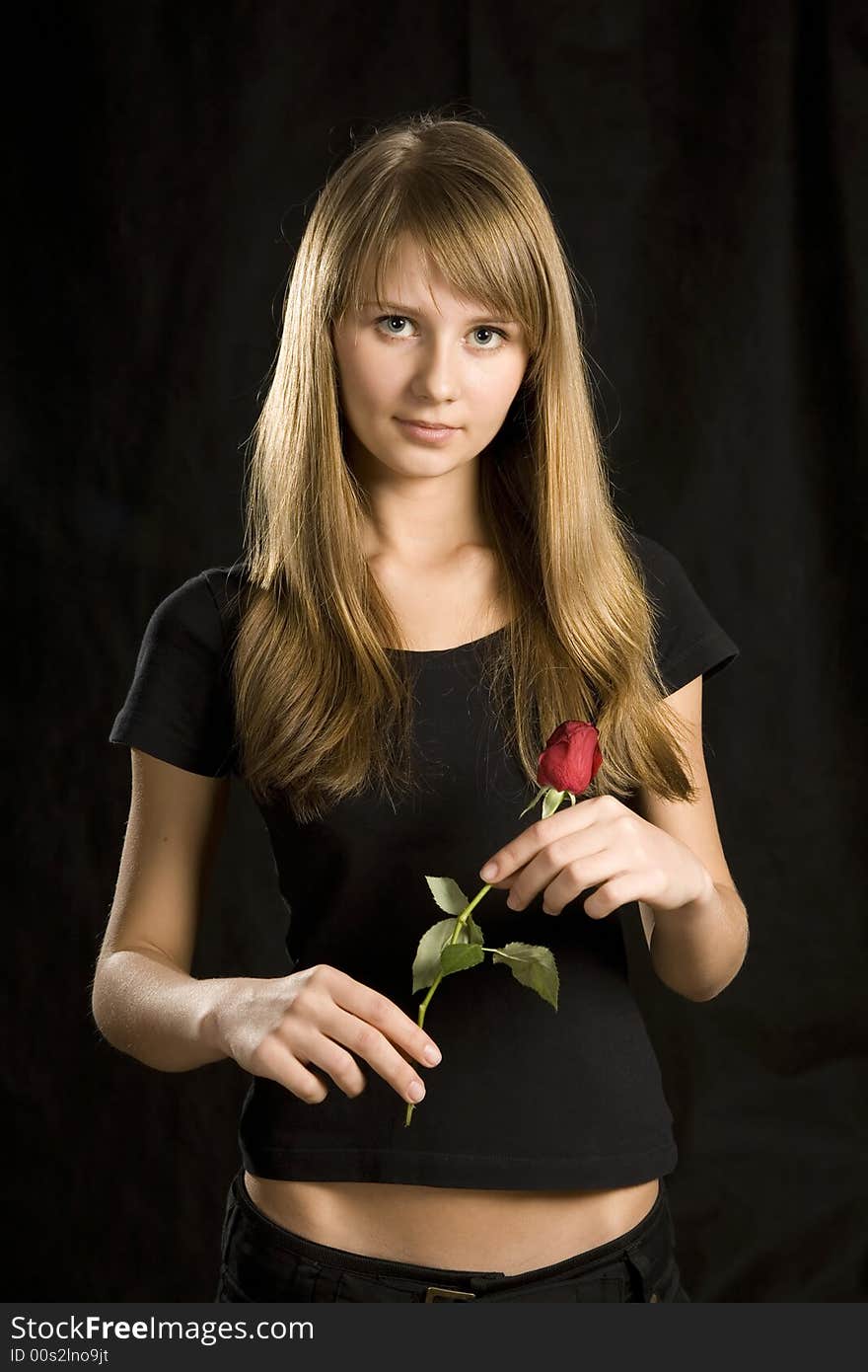 Portrait of young woman with rose