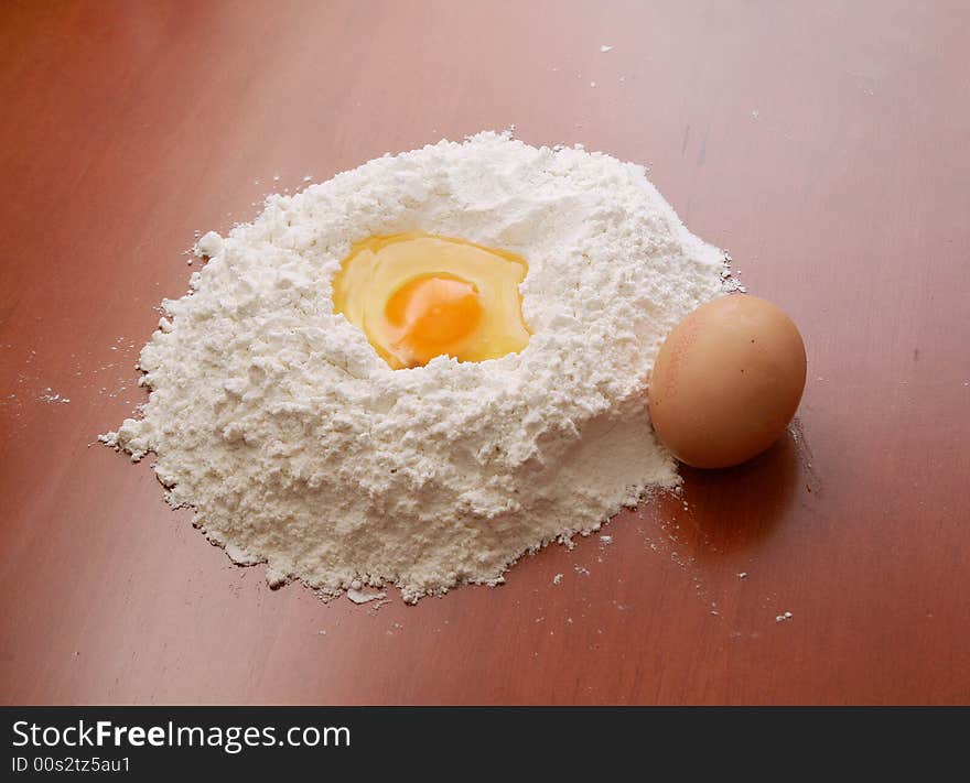 Flour and eggs on wooden table