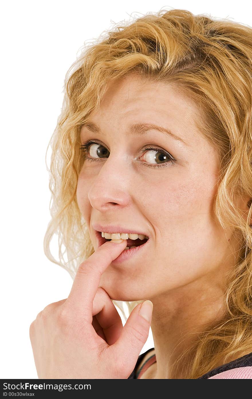 Young blond woman in thinking gesture and between teeth; lateral view; close up. Young blond woman in thinking gesture and between teeth; lateral view; close up