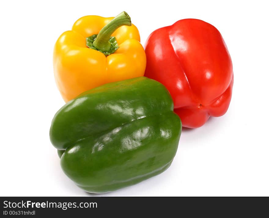 Red, yellow and green paprika on white background