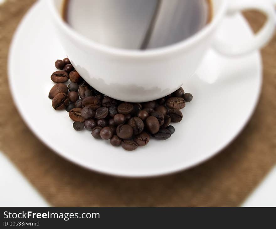 Coffee beans on a cup of coffee