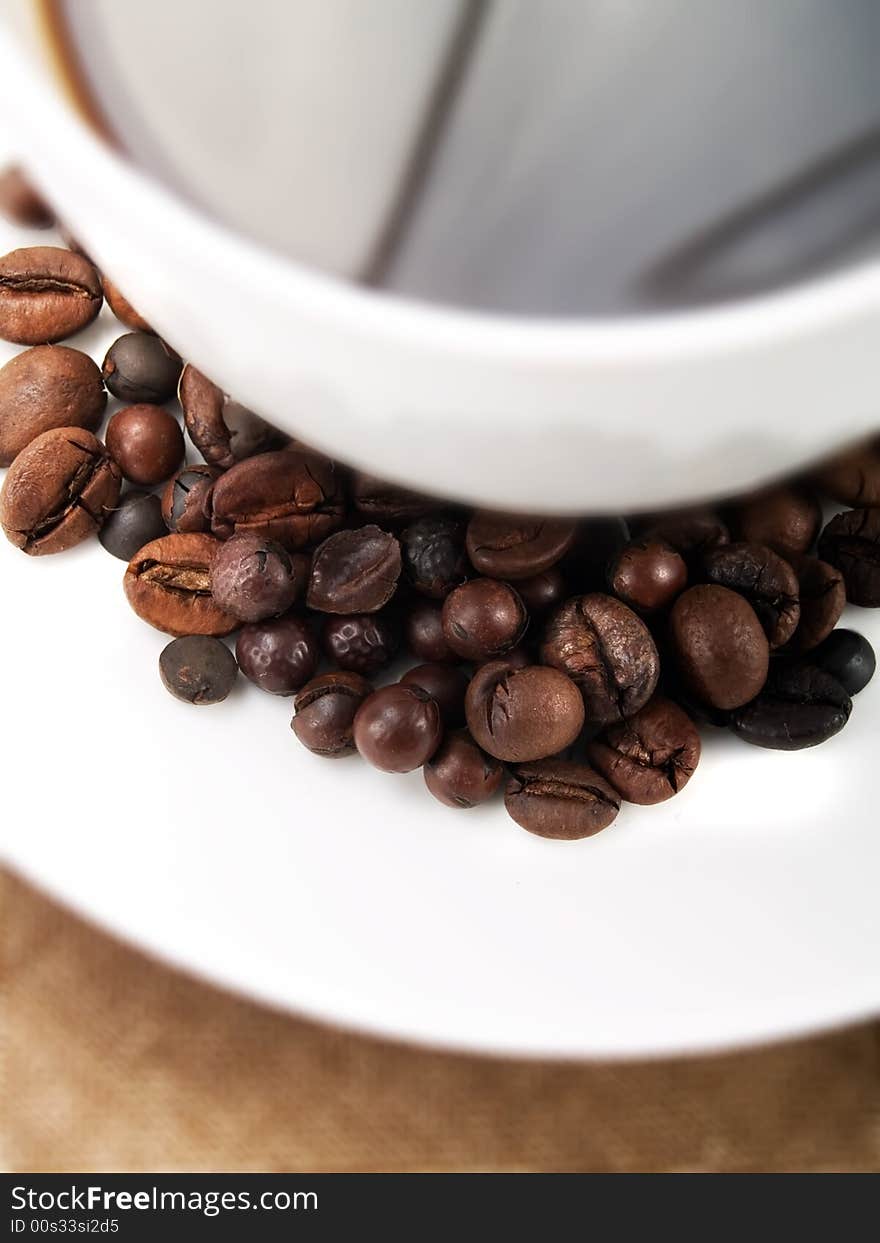 Coffee beans on a coffee cup