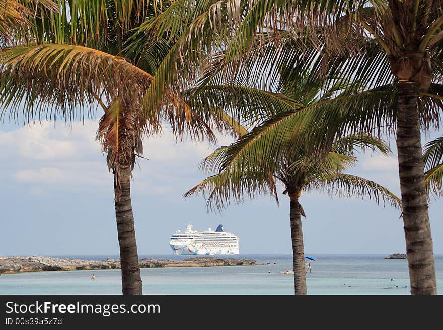 Cruise ship anchored off the shore of a tropical resort island. Cruise ship anchored off the shore of a tropical resort island.