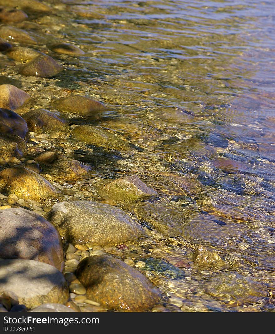 The colorful clear water by stone beach of Lake Michigan. The colorful clear water by stone beach of Lake Michigan