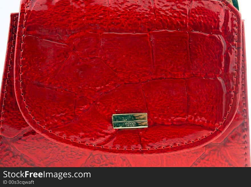 Red leather wallet with golden plate macro shot