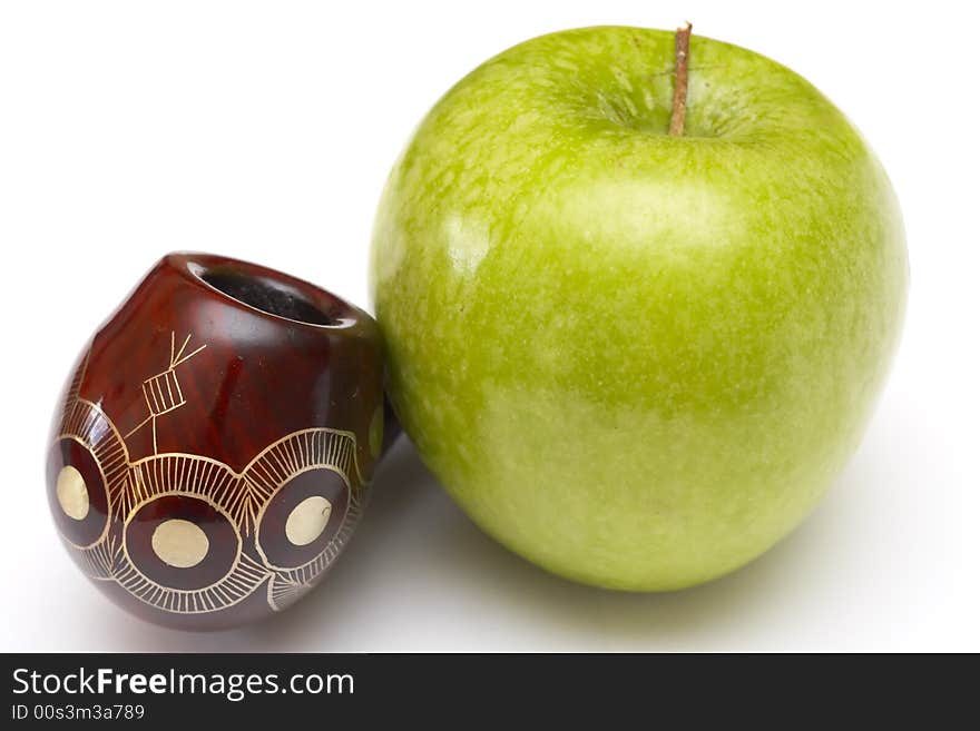 Long ornamented north-caucasian pipe with big green apple at white background. Long ornamented north-caucasian pipe with big green apple at white background