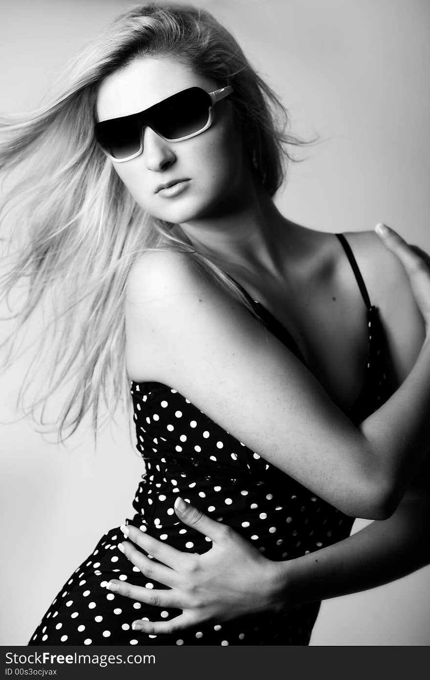 Girl with sunglasses looking down