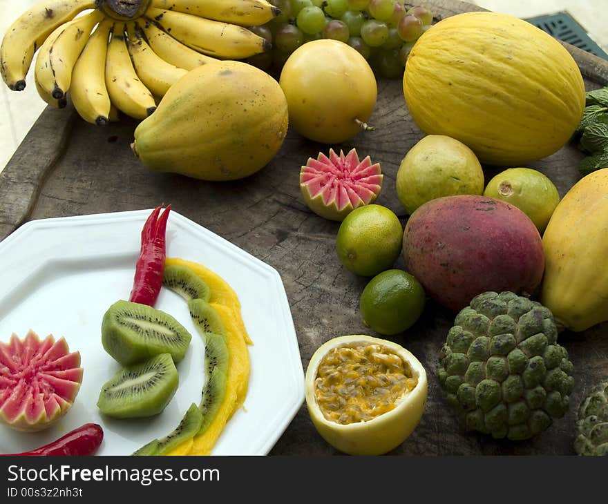 Exotic fruits on plate and wooden block