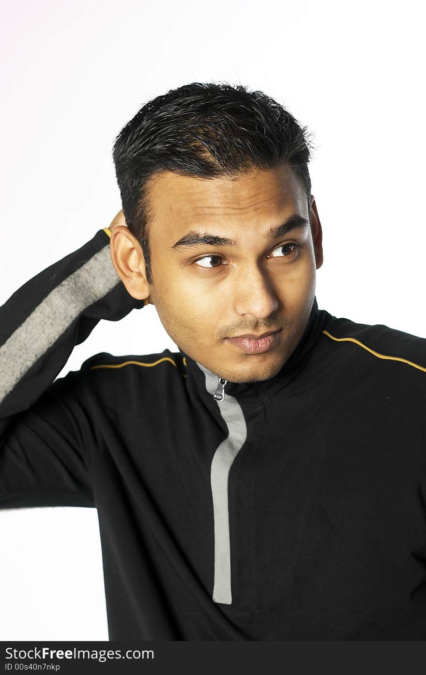 Young indian man in sweater with hand behind his head. Young indian man in sweater with hand behind his head