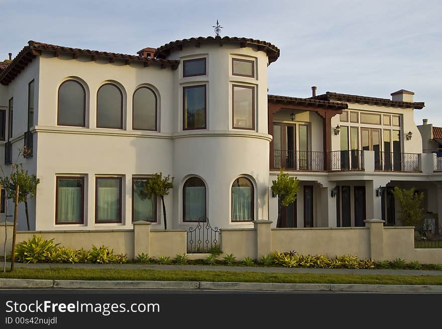 A stately white stucco house in southern California on a brisk winter morning. A stately white stucco house in southern California on a brisk winter morning.