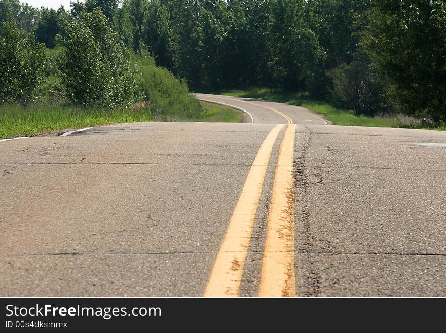 A country road curving off into the distance. A country road curving off into the distance