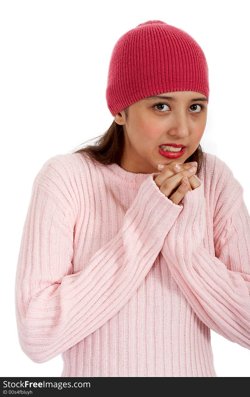 Freezing teenager in winter clothes -trying to warm her hands