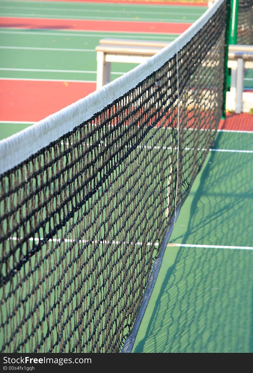 Close up detail of a tennis net stretchiing across a tennis court. Close up detail of a tennis net stretchiing across a tennis court