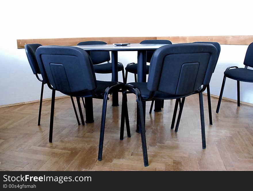 Meeting round table in office with black chairs
