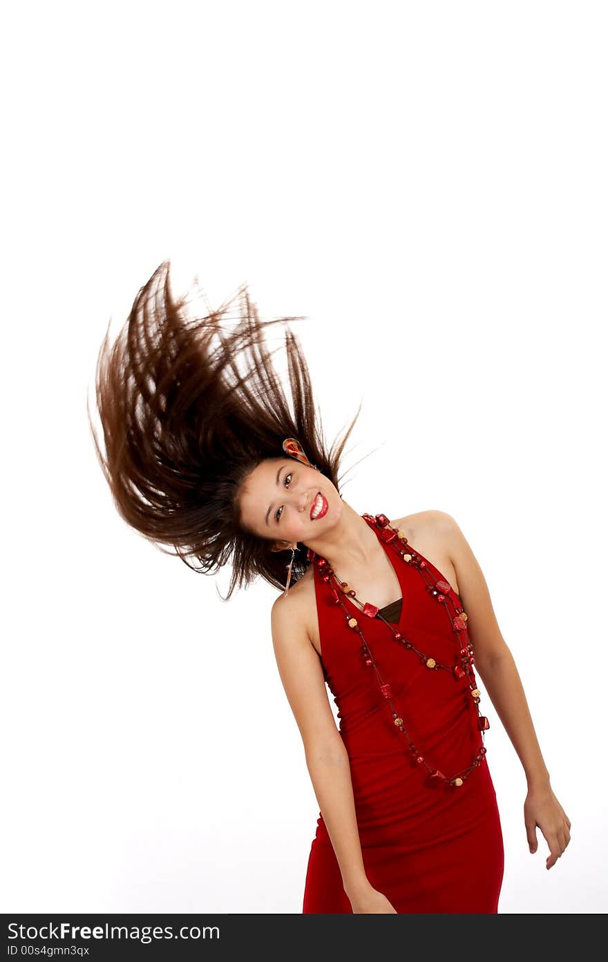 Pretty woman in red dress waving her hair