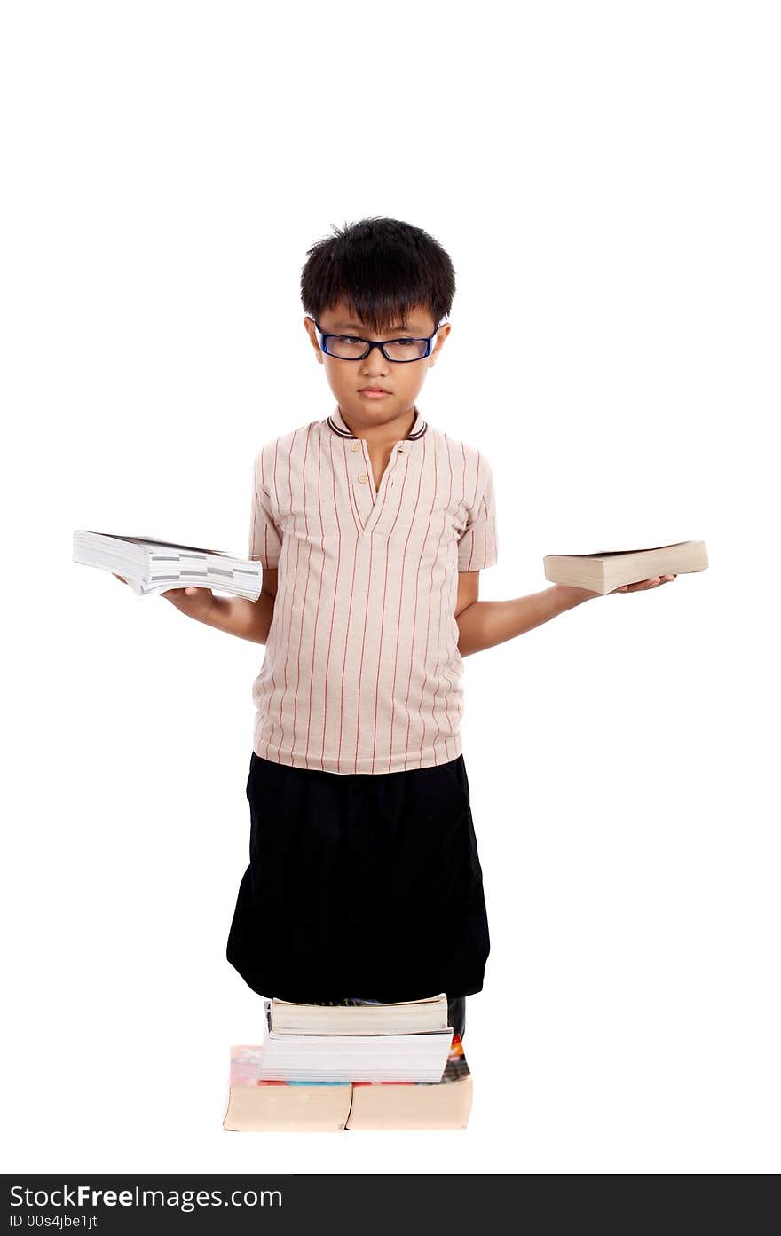 Young boy kneeling on a stack of books