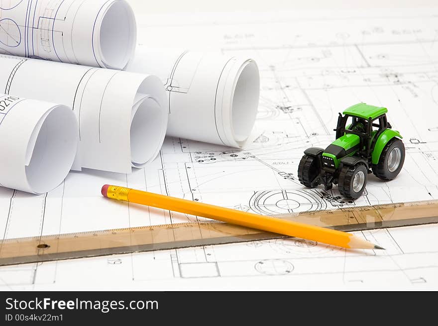 Constructor drawings and scale model at engineer`s workplace