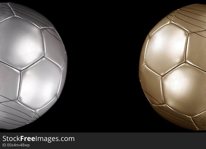 Close up of a gold and silver footballs