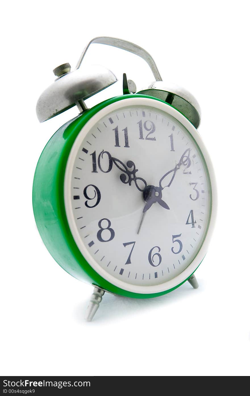 Old green alarm clock on a white background