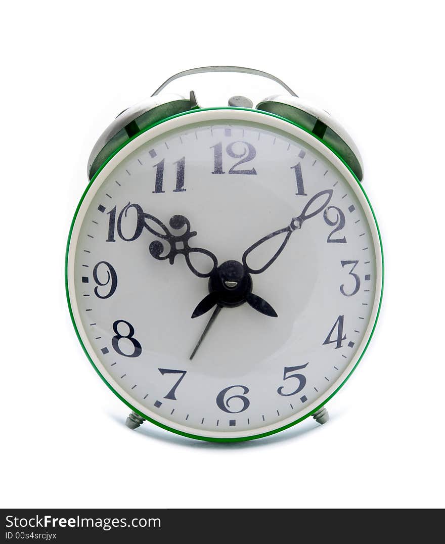 Old green alarm clock on a white background