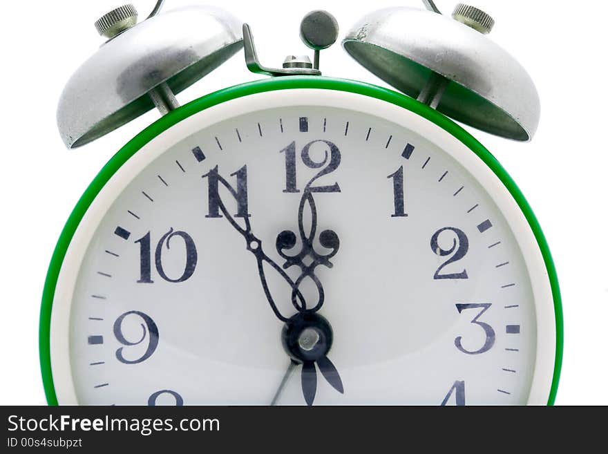 Old green alarm clock on a white background