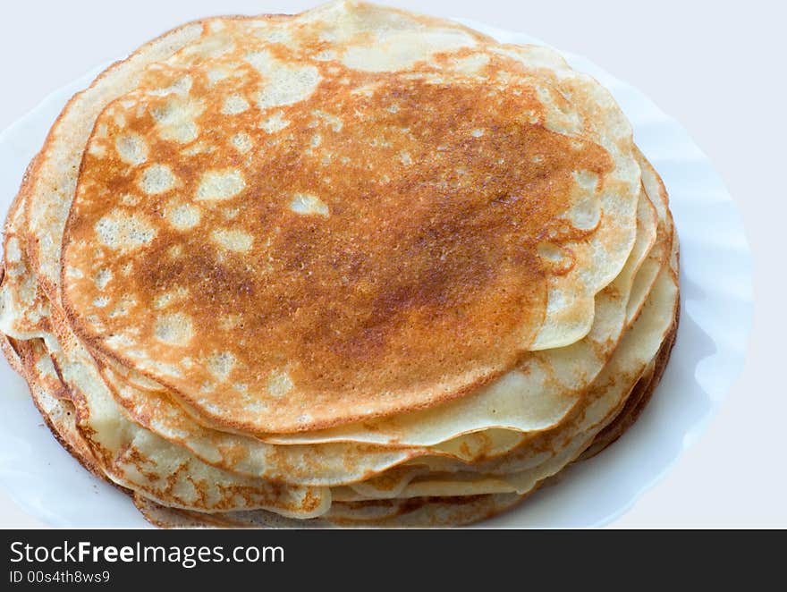 Stack of pancakes in plate on light background