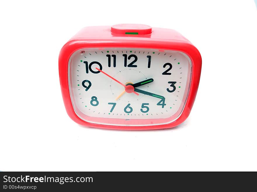 Old red alarm clock on a white background