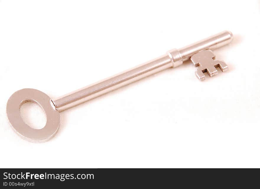 A single silver key on white cut out. A single silver key on white cut out.