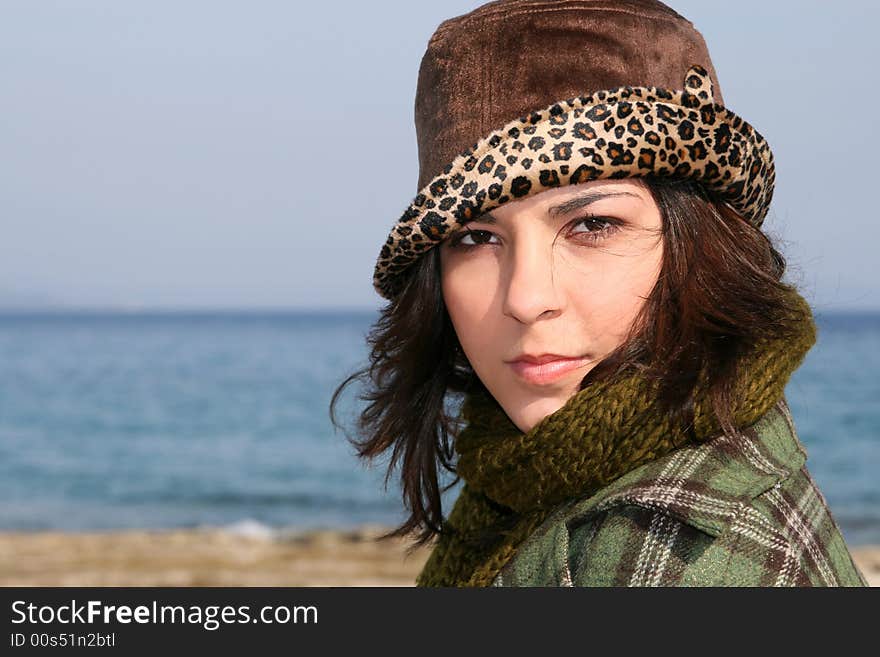 A brunette beautiful young woman at the beach. A brunette beautiful young woman at the beach