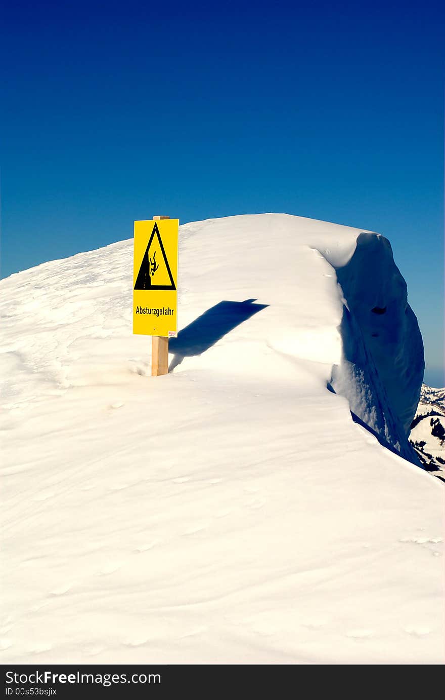 Warning sign about danger of falling hazard seen at the summit of the Nebelhorn (Foghorn) near Oberstdorf, Allgaeu Alps, South-Germany