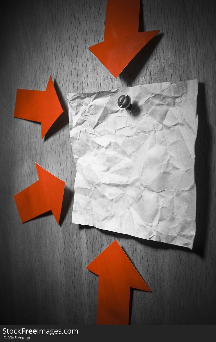 Business conceptual image. Crumpled office note paper attached to wall by and pointed by red arrows. Business conceptual image. Crumpled office note paper attached to wall by and pointed by red arrows