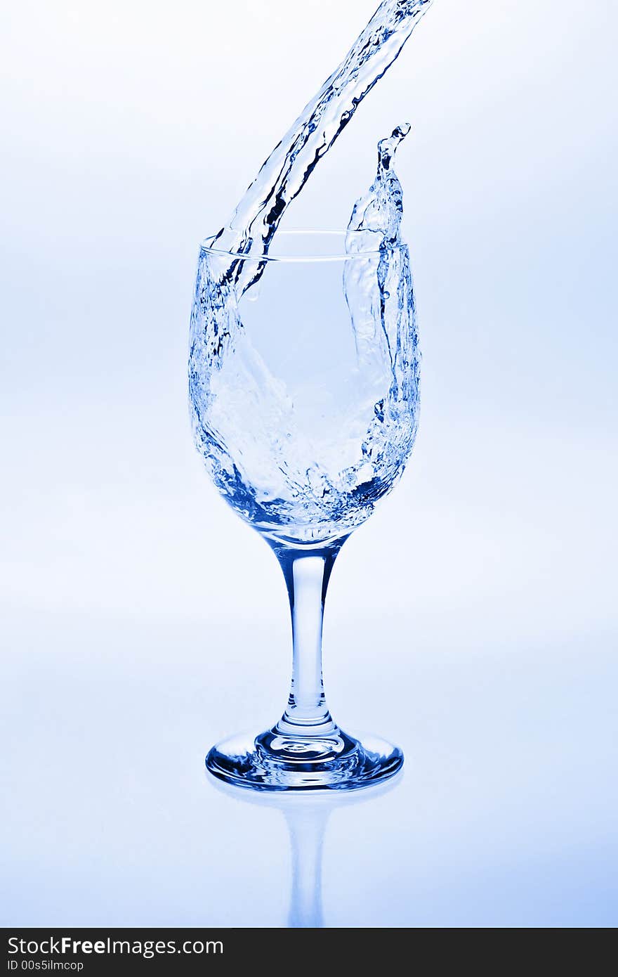 Water being poured into a wine glass. Water being poured into a wine glass.