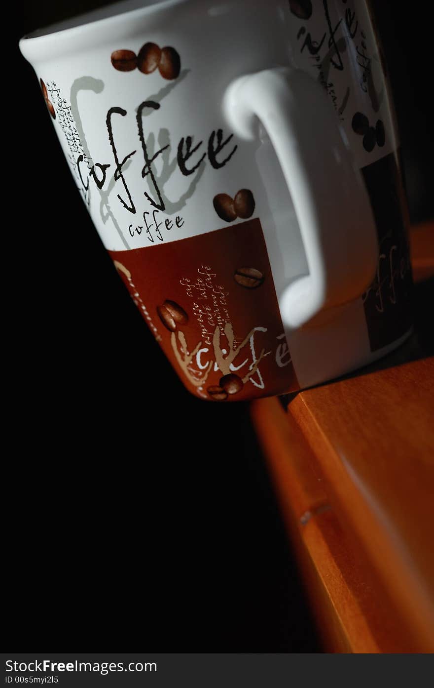 Coffee mug standing on the edge of a table. Coffee mug standing on the edge of a table