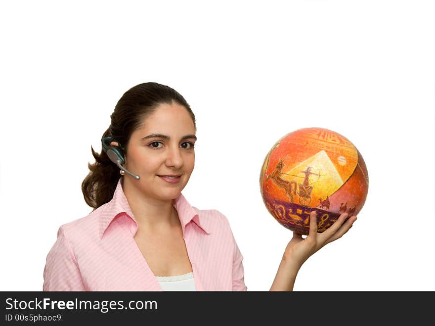 A girl, wearing a blue-tooth earpiece, holding a puzzle ball, looking at a camera. A girl, wearing a blue-tooth earpiece, holding a puzzle ball, looking at a camera