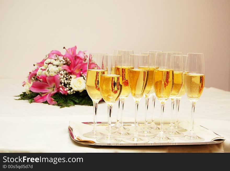 Several glasses of champagne with flower decoration on the table. Several glasses of champagne with flower decoration on the table