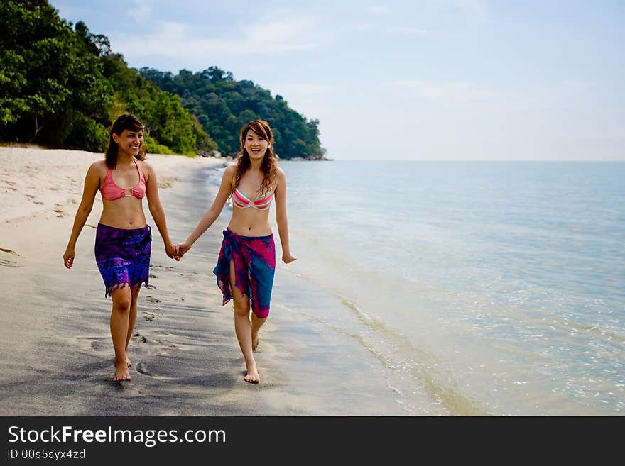 Girlfriends Strolling By The Beach