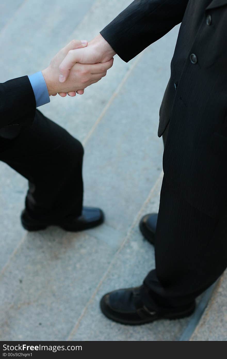 Businessman Gives a Handshake while he's stepping forward. Businessman Gives a Handshake while he's stepping forward