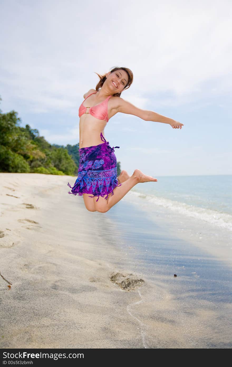 Jumping Freely At The Beach