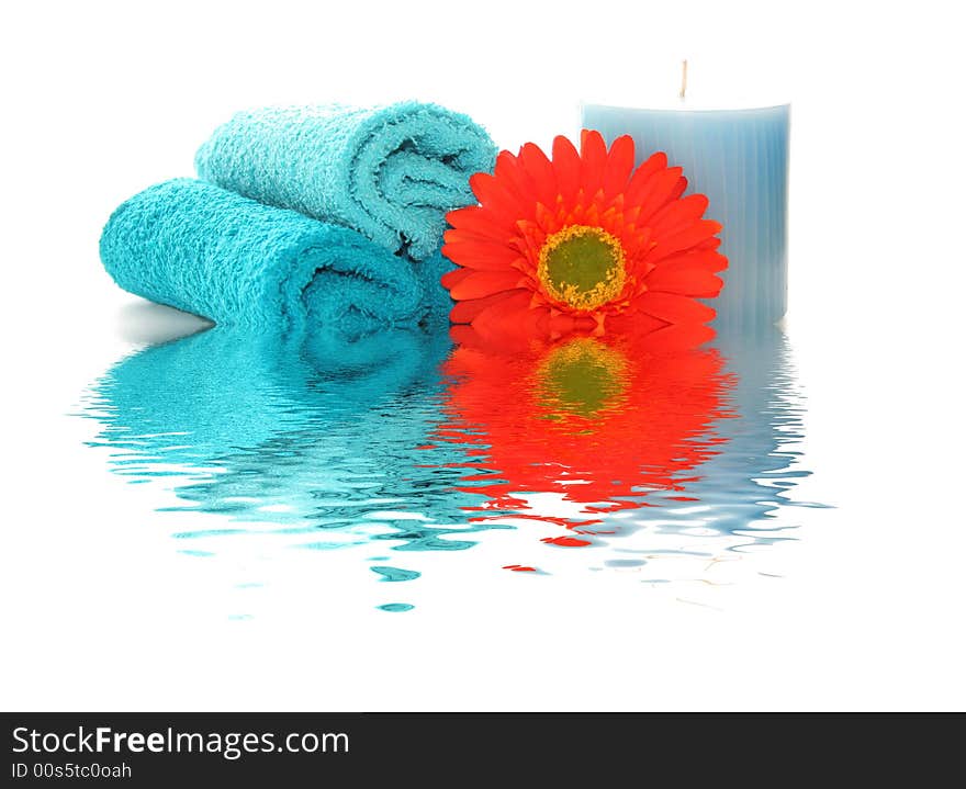 spa like image with a candle, flower and wash cloths with a rippled reflection. spa like image with a candle, flower and wash cloths with a rippled reflection.