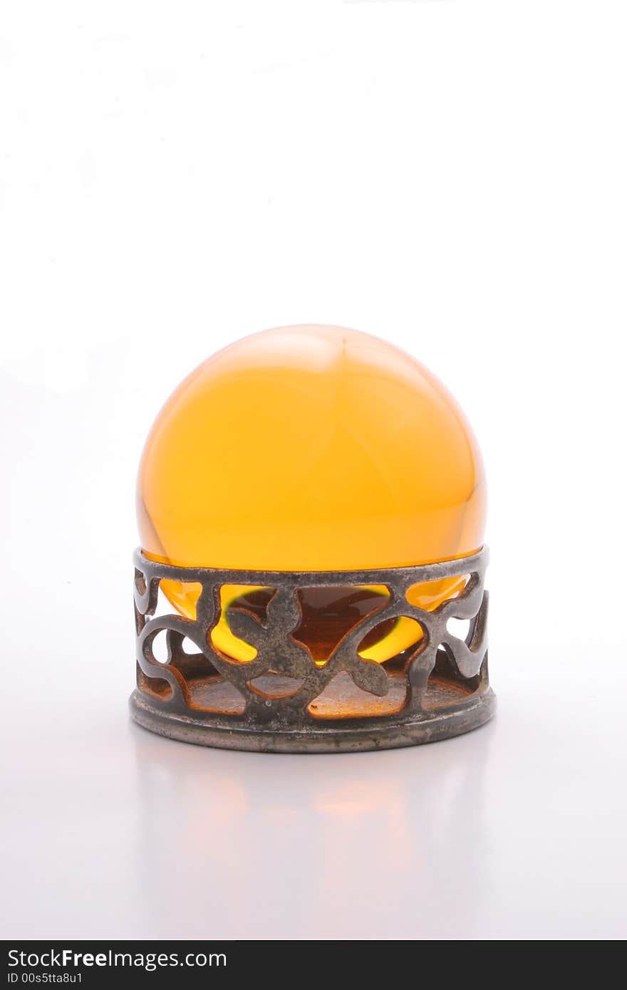 Yellow crystal ball on a metal stand