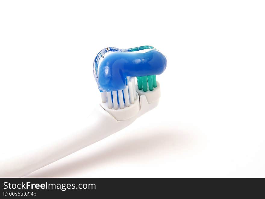 Toothbrush with clear gel toothpaste on bristles over white background. Toothbrush with clear gel toothpaste on bristles over white background