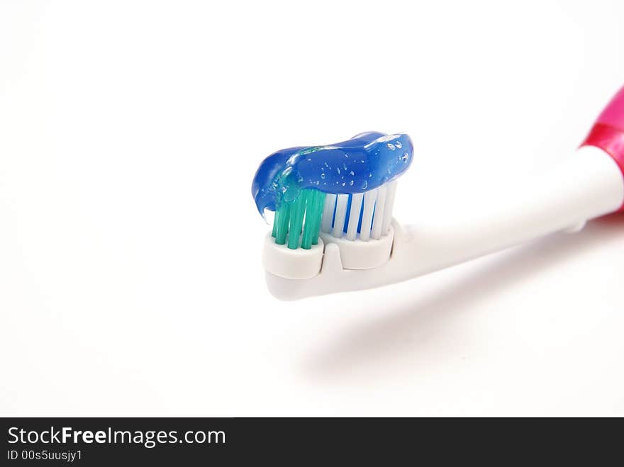 Toothbrush with clear gel toothpaste on bristles over white background. Toothbrush with clear gel toothpaste on bristles over white background