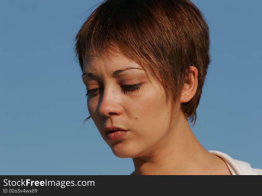 Portrait of a young woman with the blue sky in background. Portrait of a young woman with the blue sky in background