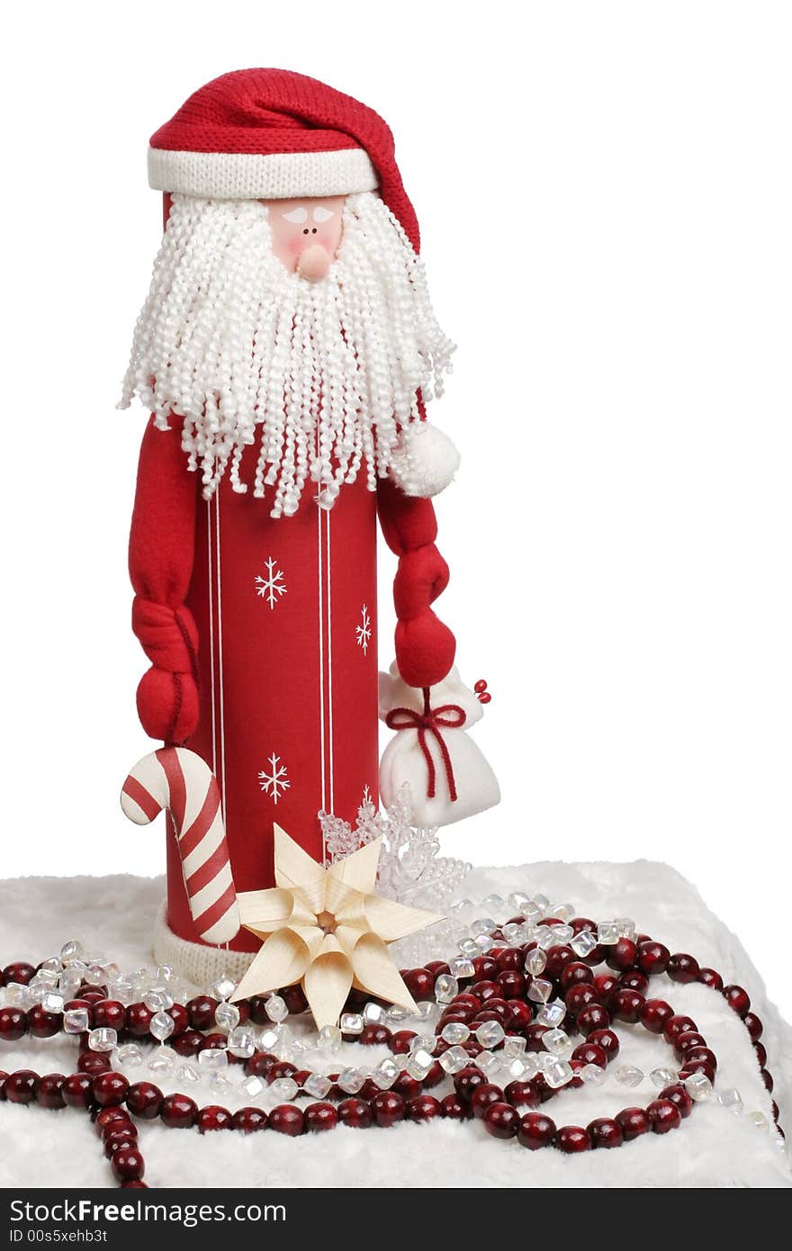 Toy Santa figurine holding a candycane and gift with decorations below.