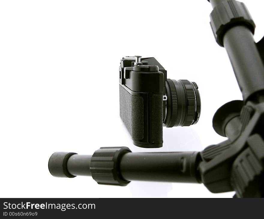 Black tripod and camera isolated on white