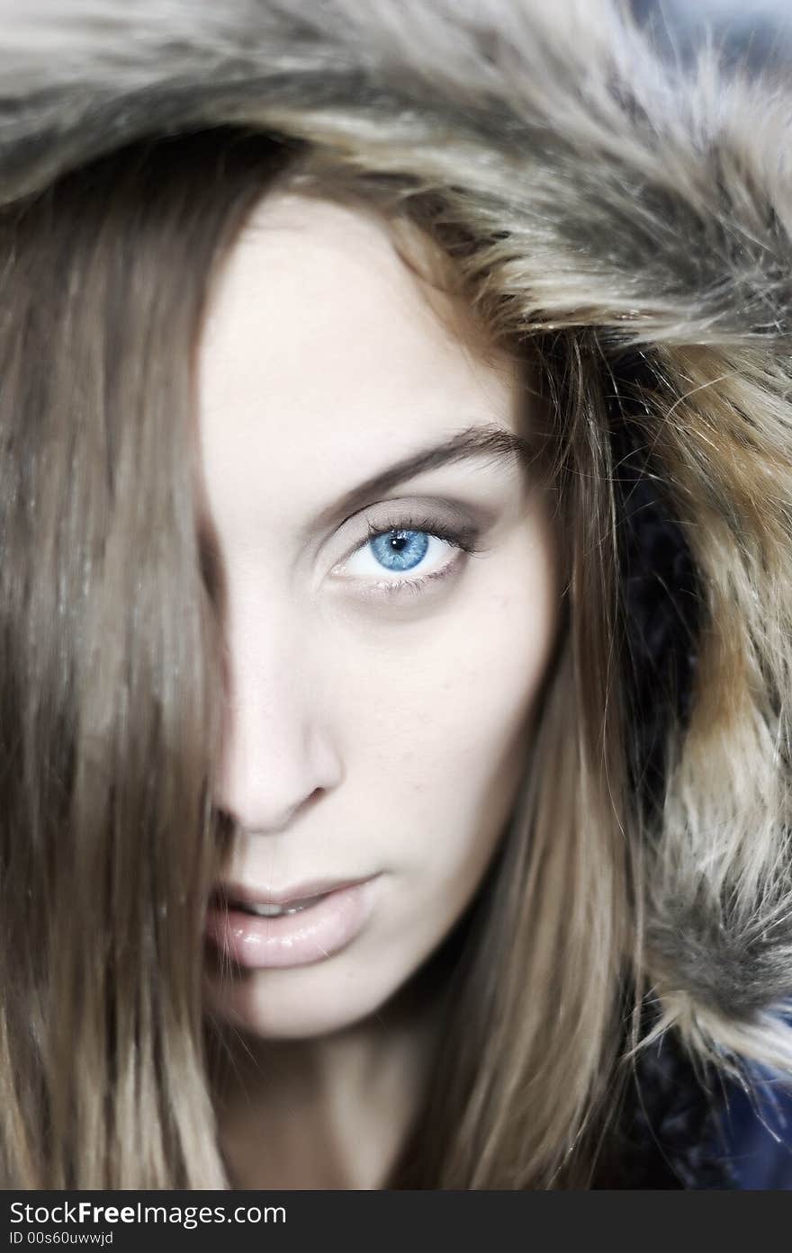 Portrait of a beautiful blue eyed young woman with a hood. Portrait of a beautiful blue eyed young woman with a hood