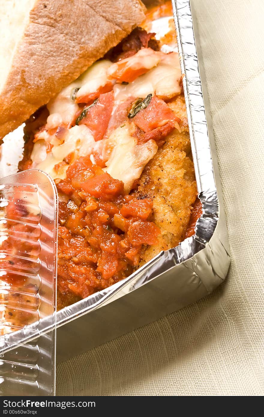 Carry out meal chicken parmesan with a slice of bread in the carry out container. Carry out meal chicken parmesan with a slice of bread in the carry out container